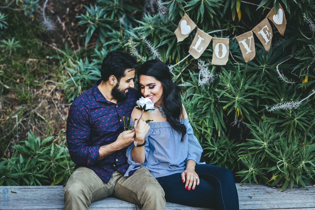 Indian couple posing outdoors for engagement photo session. | Photo 260070