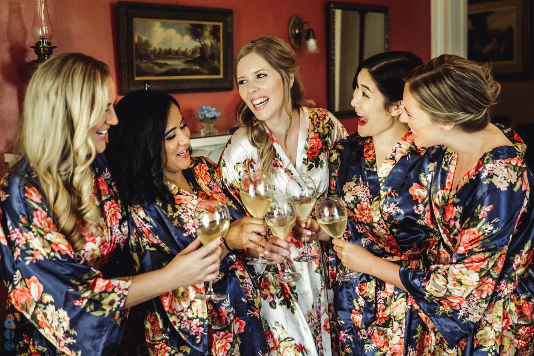 The Bride and her bridesmaids getting a drink before getting ready for the destination wedding in Napa Valley.