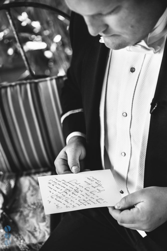 The Groom, Chris, reading a note from the bride.