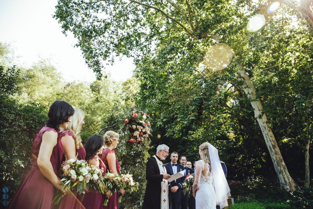 Wedding Photography of the ceremony at Madrona Manor with sun flares. Destination Wedding in Napa Valley.