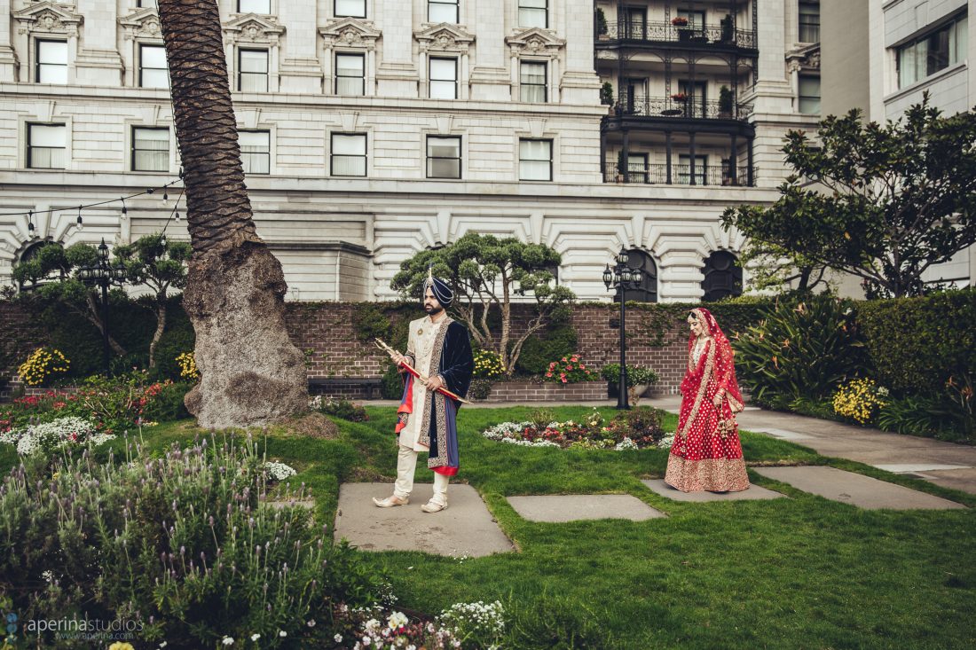 Indian bride in red lehenga and groom first look in a rooftop garden at Fairmont SF