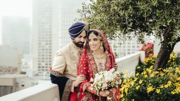 Indian bride in red lehenga and groom portrait on the rooftop of Fairmont San Francisco