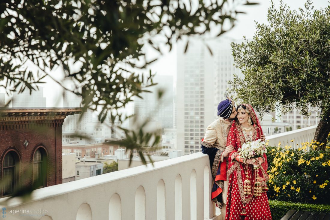 Indian bride in red lehenga and groom portrait on the rooftop of Fairmont San Francisco