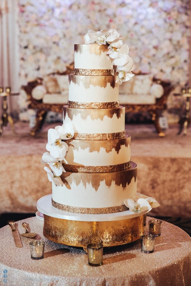 Indian wedding reception floral decor design gold 5 layer cake in the Fairmont San Francisco