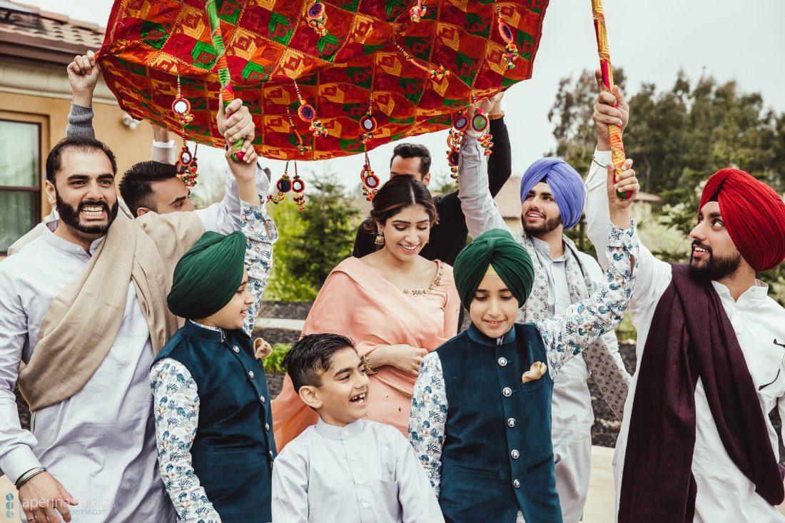 Chunni Ceremony - Bride walking with her family - Wedding Photography