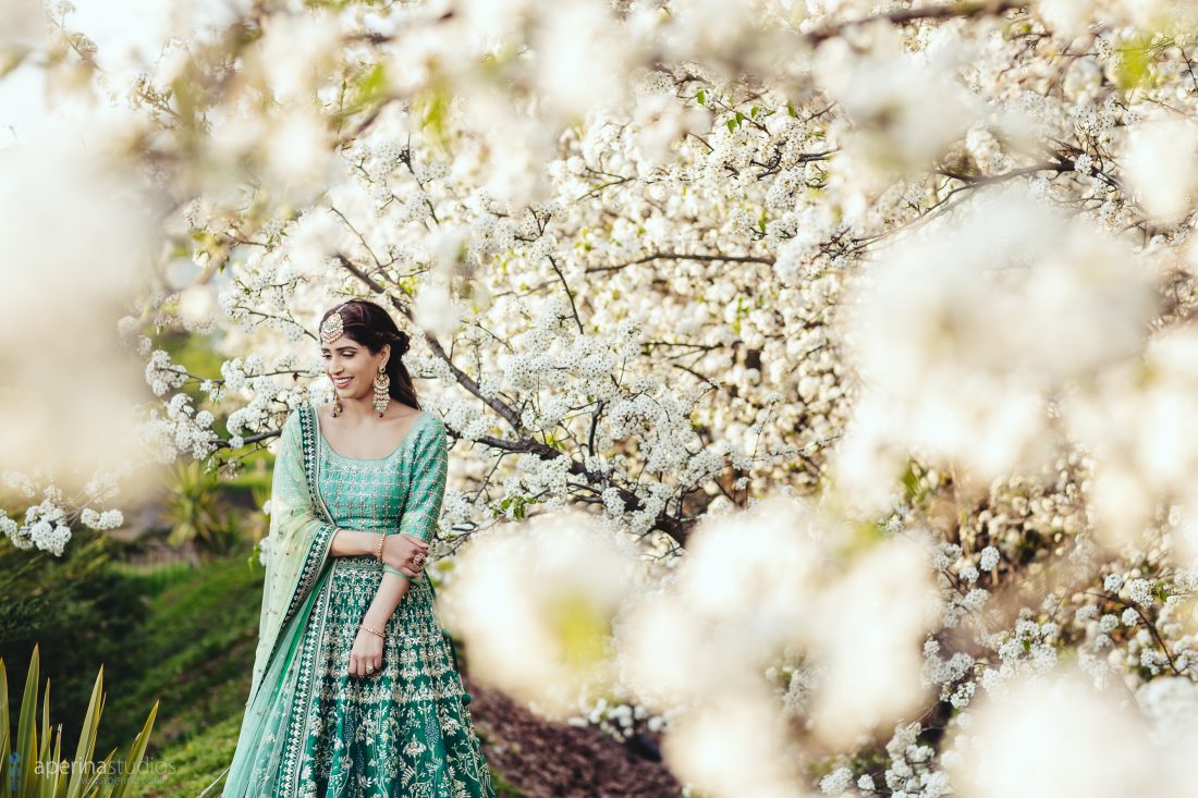 Navroop, an Indian Bride wearing stunning blue and green Anita Dongre lehenga on her Sangeet