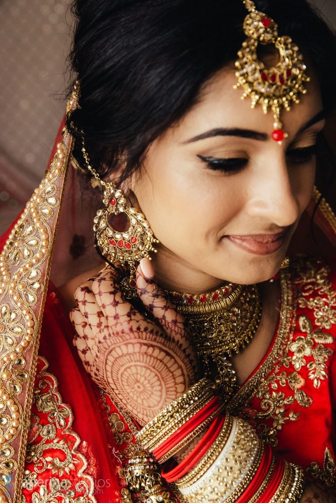 Indian wedding photography - Bride portrait in red lehenga dress and gold jewelry