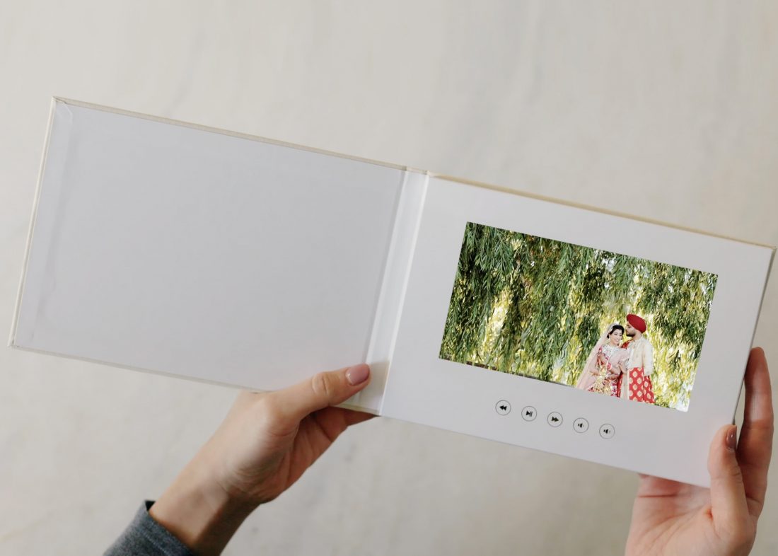 A new way to deliver wedding film - On a wedding video book.